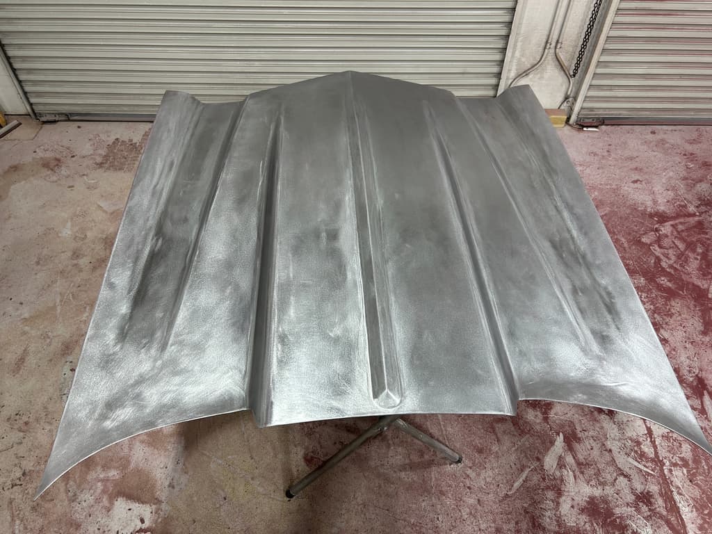 Cowl induction hood on a stand, sanded to bare metal